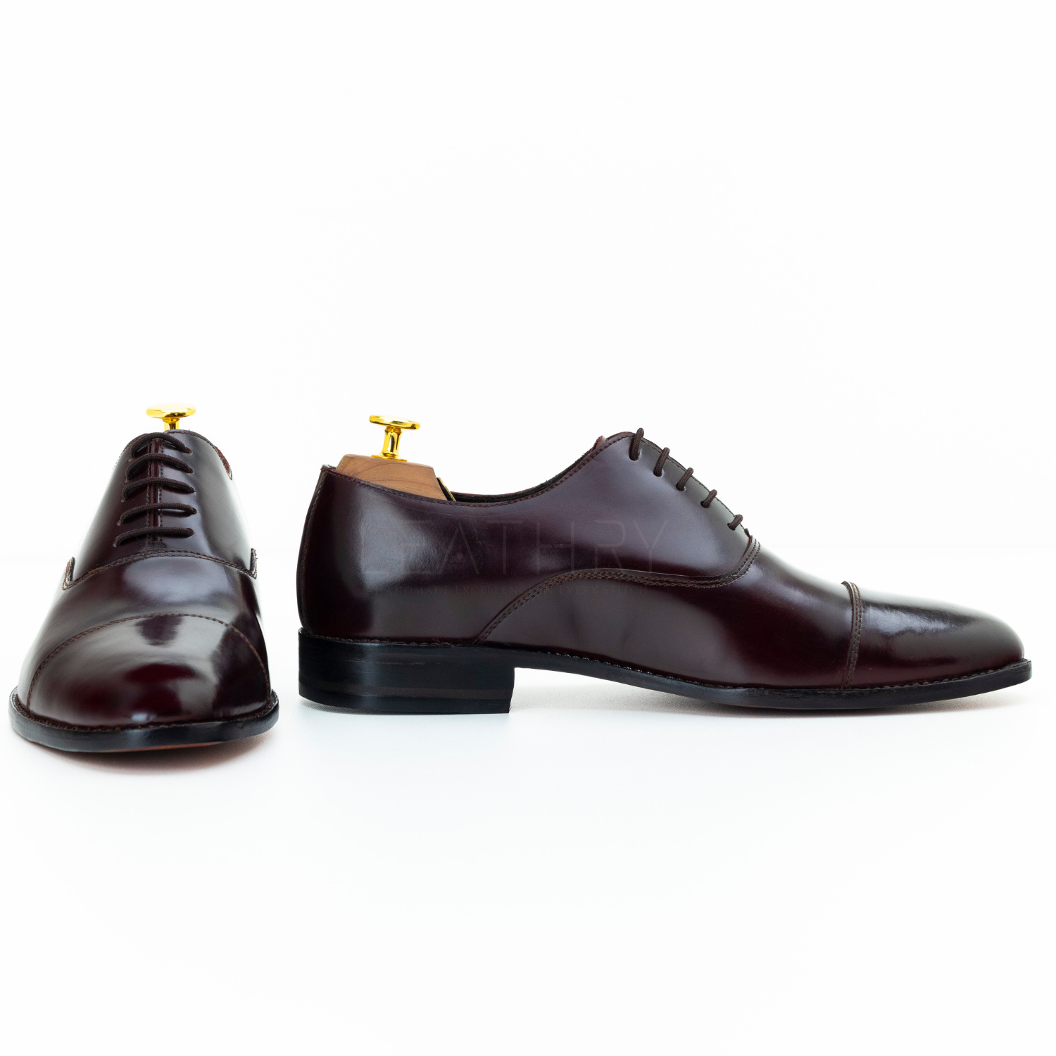 Pair of brown leather dress shoes on a white background
