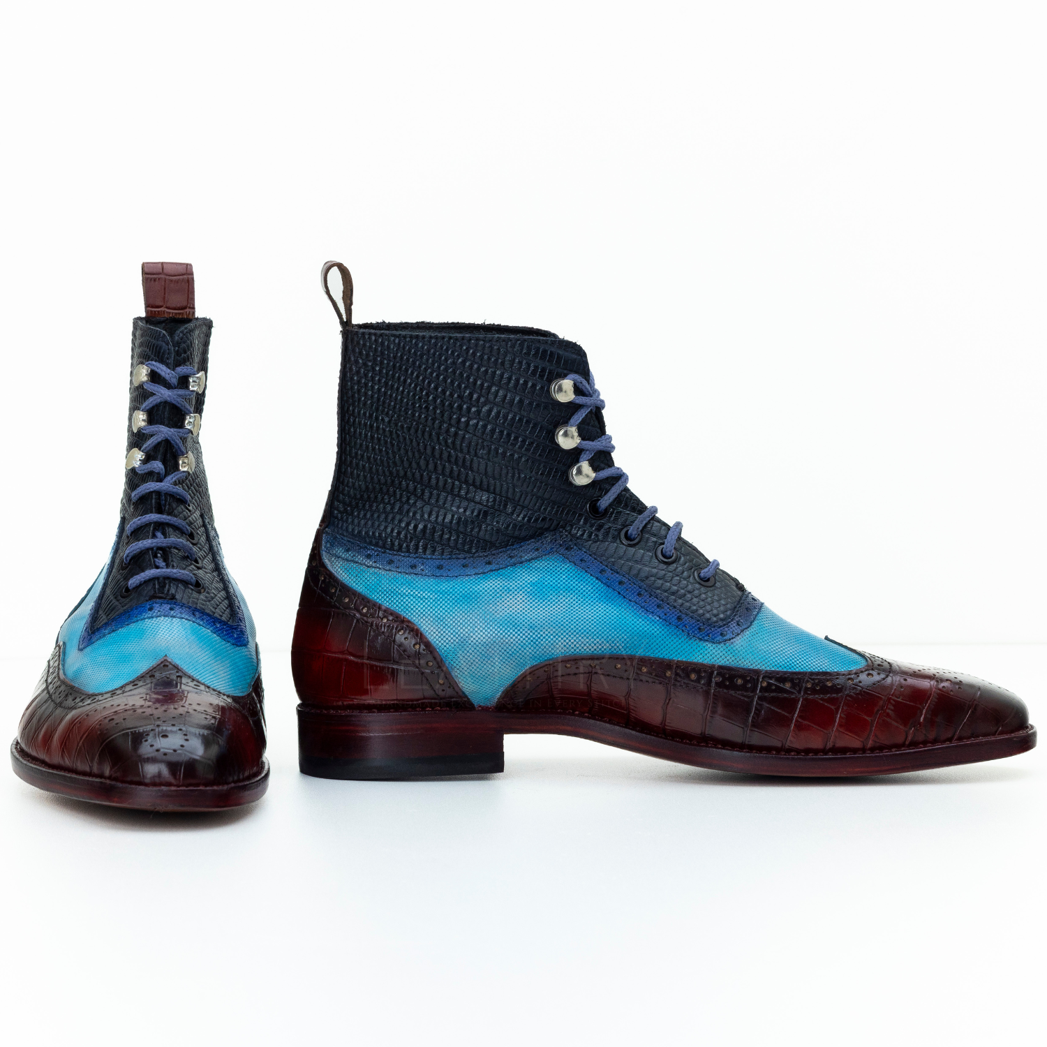 Pair of multicolored boots with blue, black, and brown design on a white background