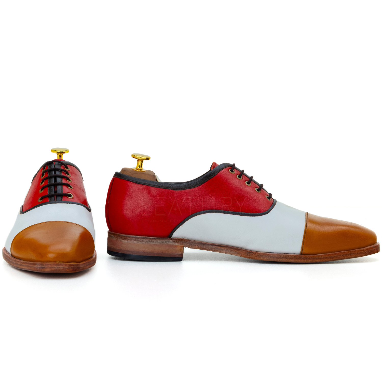 Color-blocked dress shoes with red, white, and brown sections on a white background