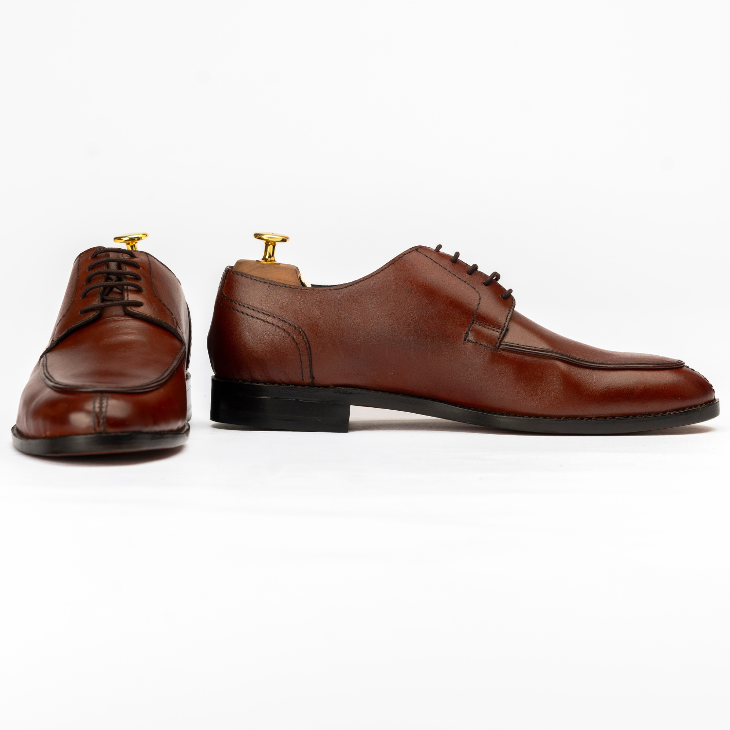 Pair of brown dress shoes on a white background