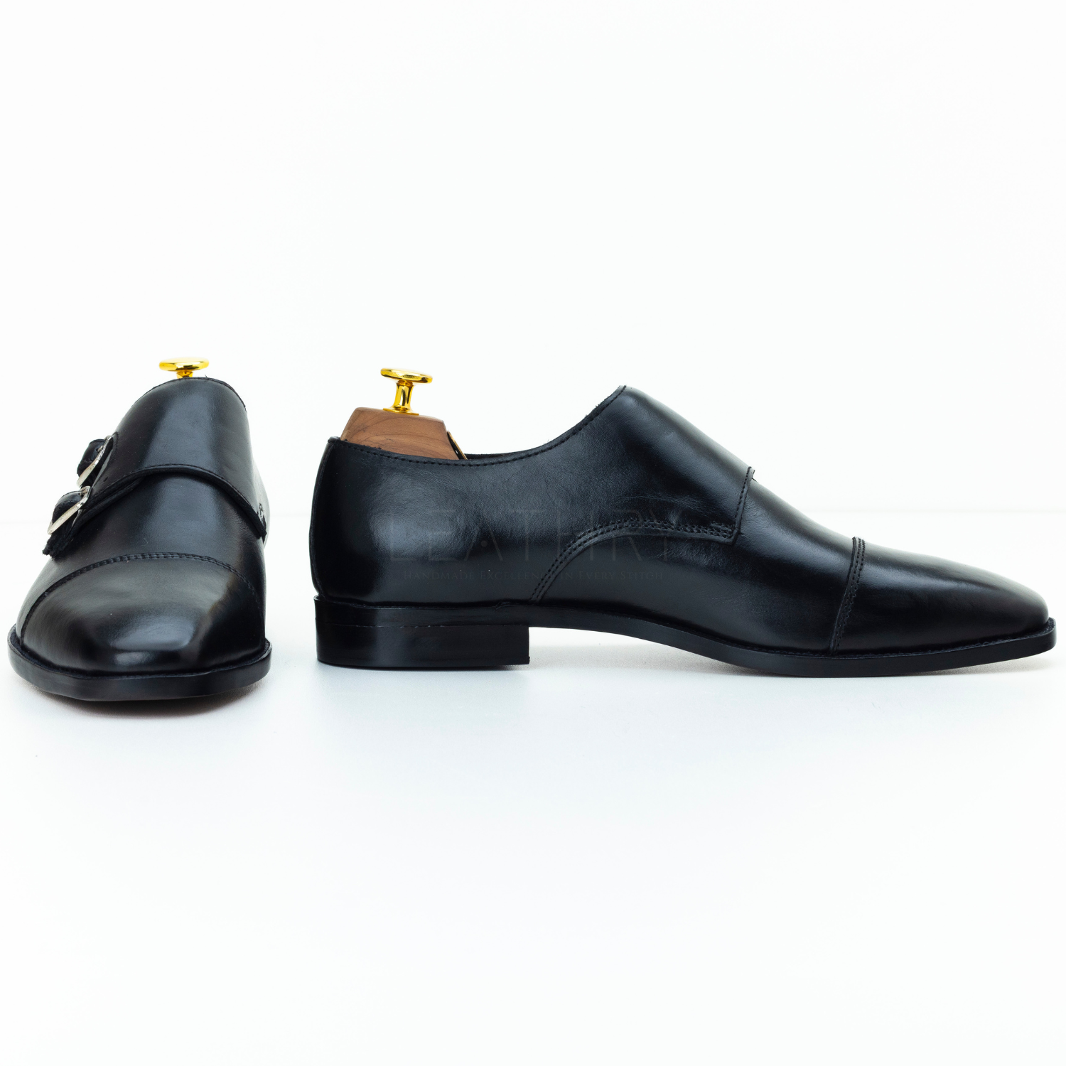 Pair of black dress shoes on a white background