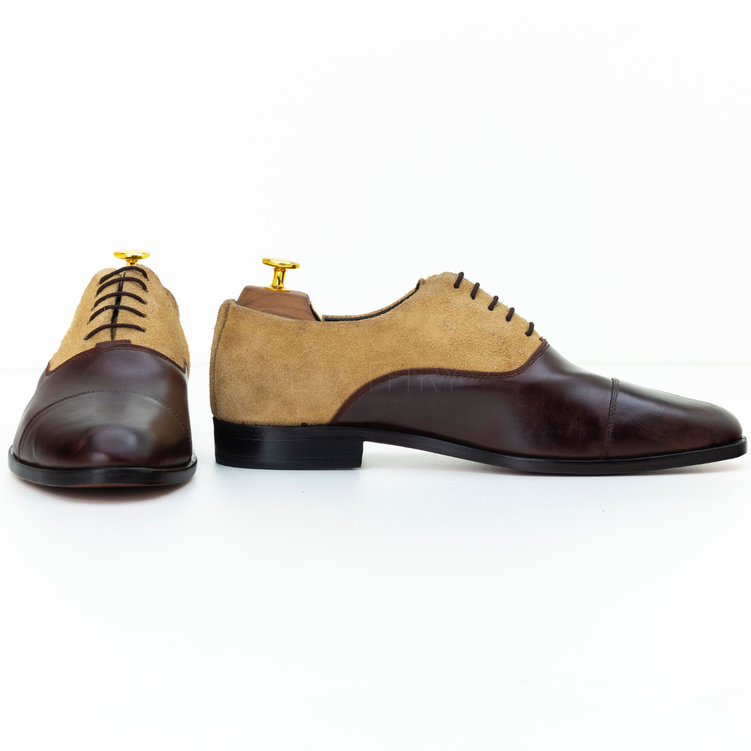 Brown and beige dress shoes on a white background