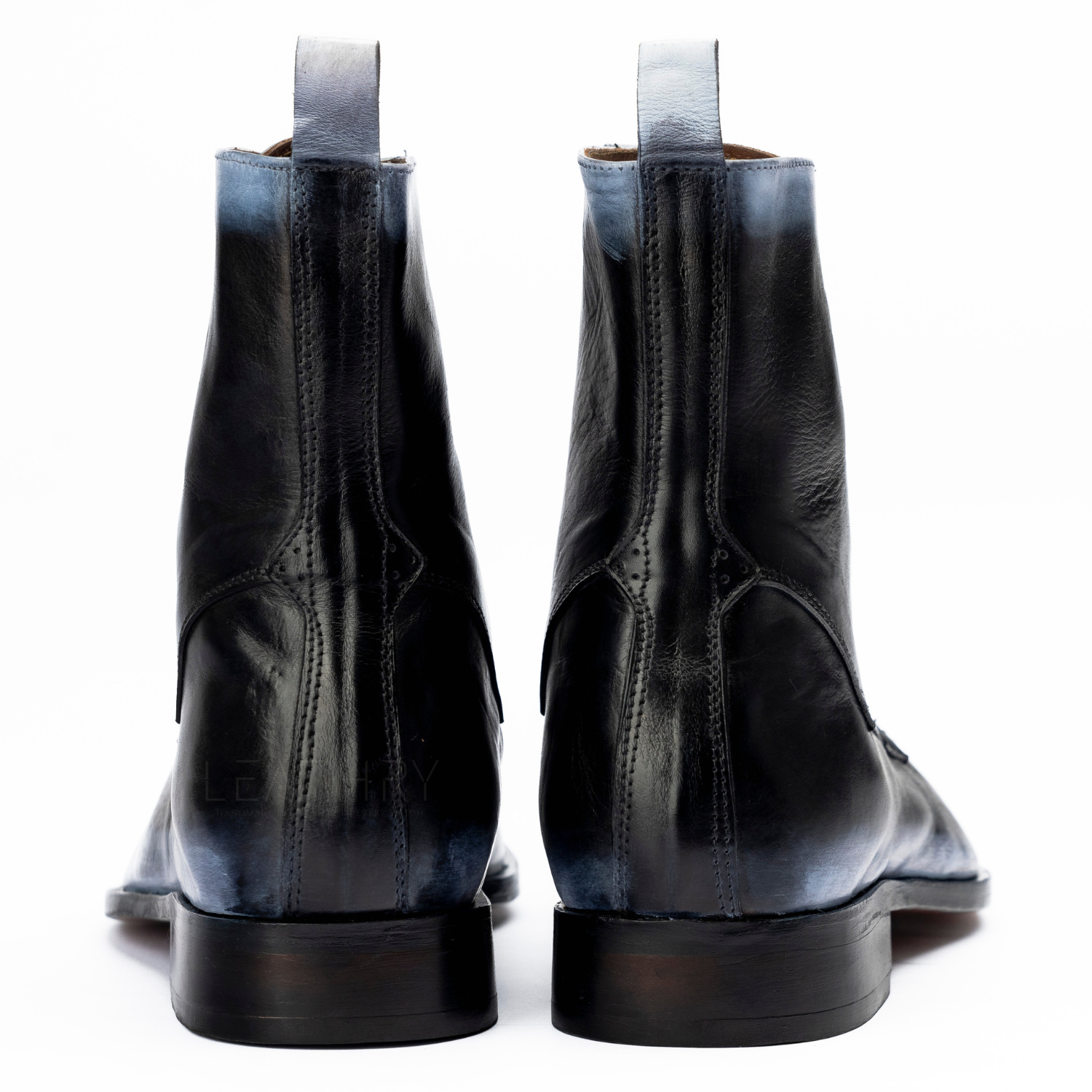 Black leather boots with a white background