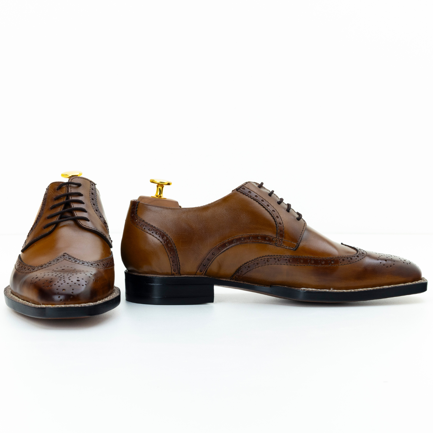 Pair of brown leather dress shoes on a white background