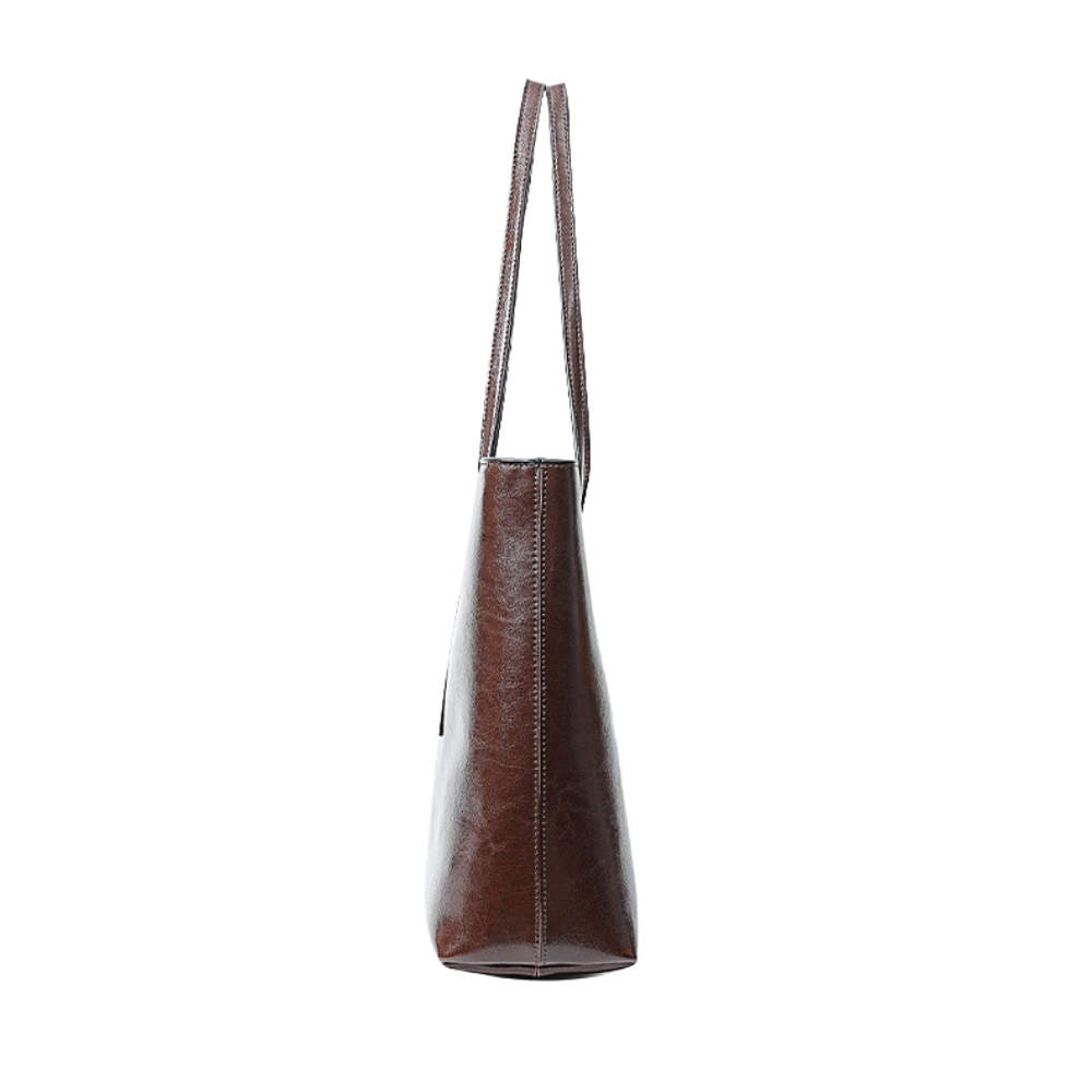 Brown leather handbag with a long handle on a white background