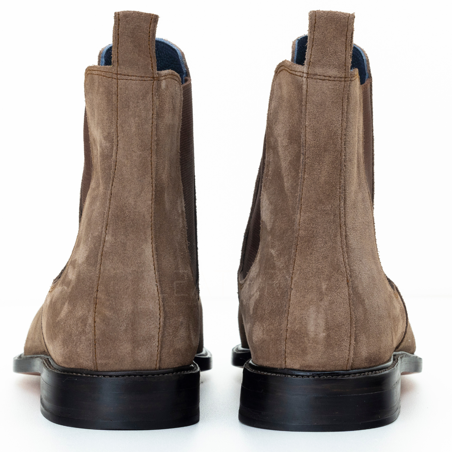 Pair of brown suede boots on a white background