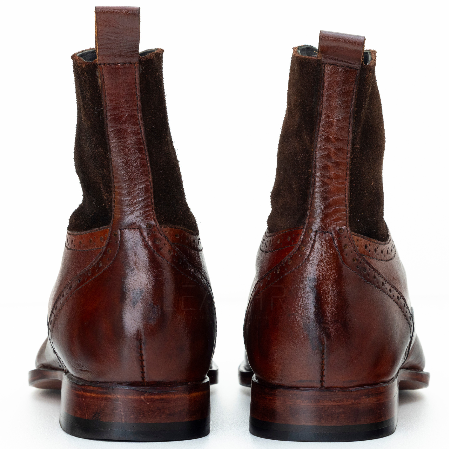 Pair of brown leather boots on a white background