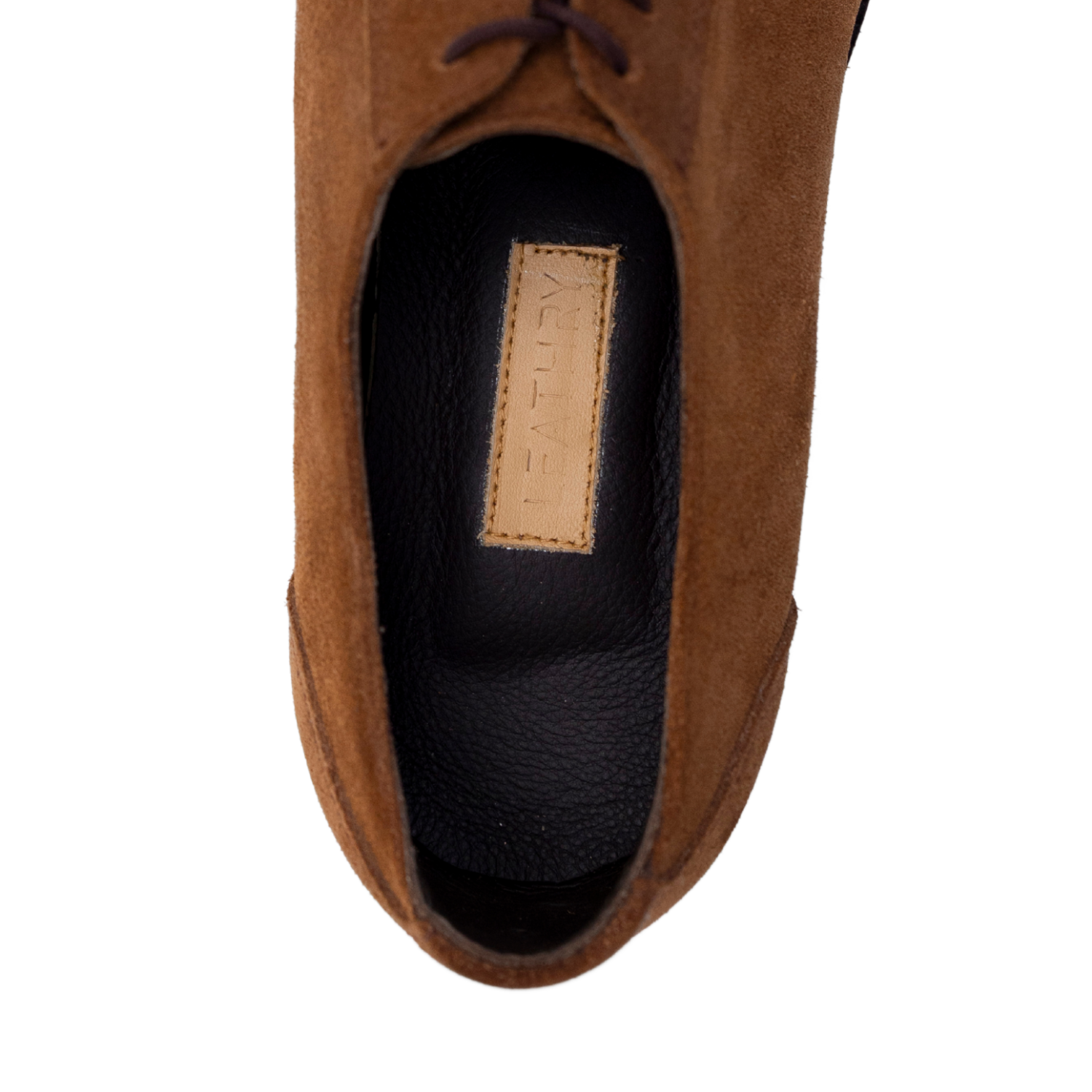 Brown suede shoe with a brand label on a white background