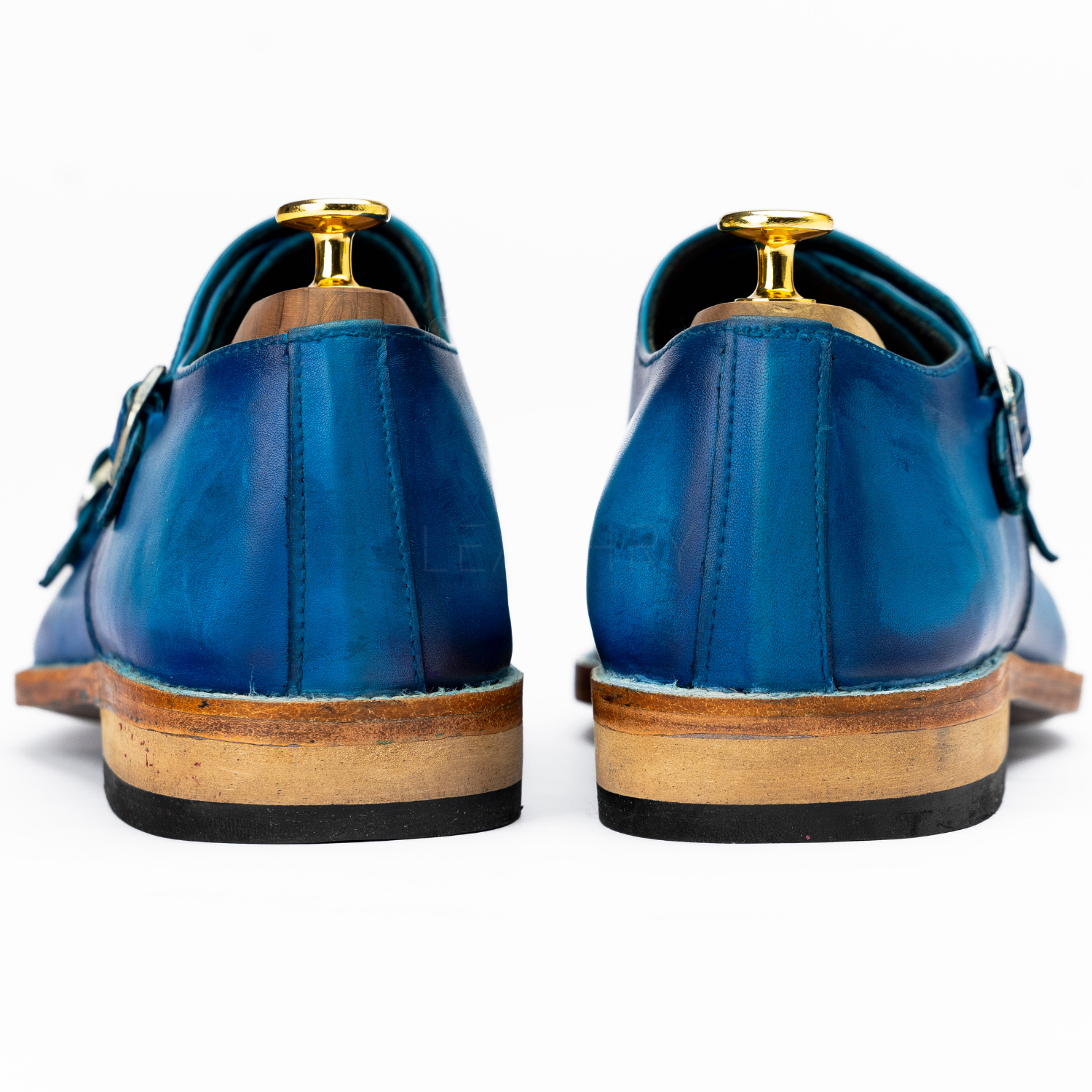 Blue leather shoes with wooden soles on a white background