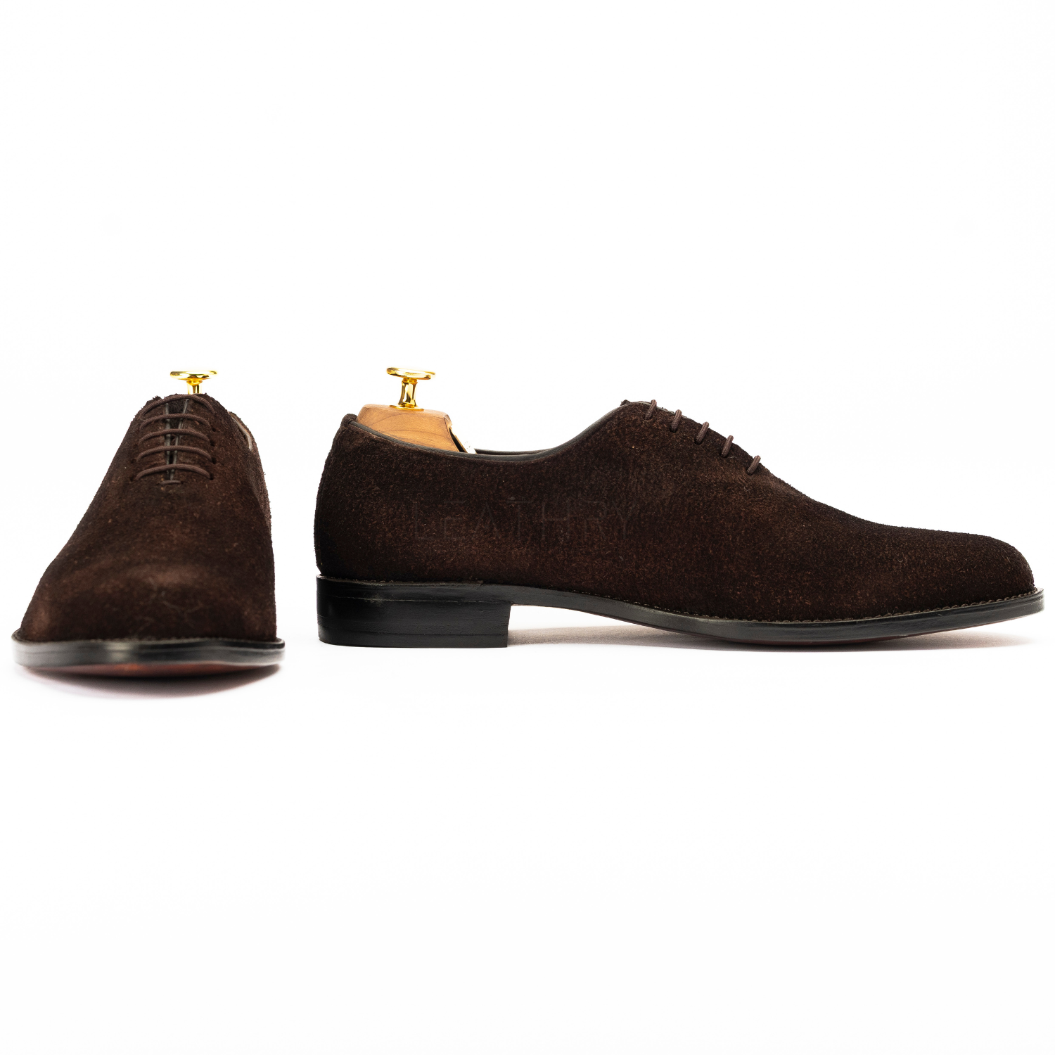 Brown suede dress shoes on a white background