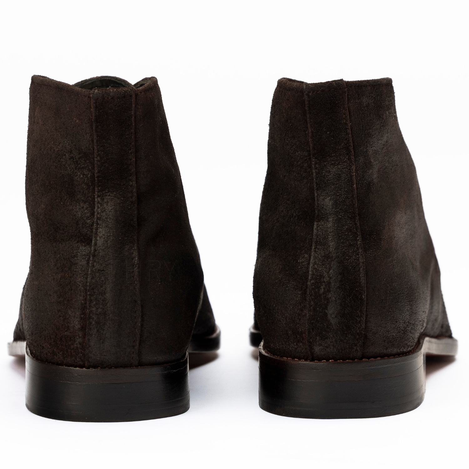 Pair of dark brown suede boots on a white background
