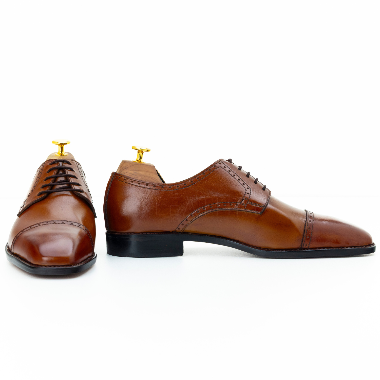 Brown leather dress shoes on a white background
