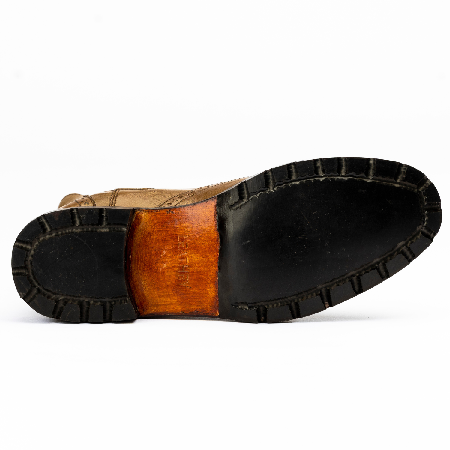 Close-up of a leather shoe sole with a white background