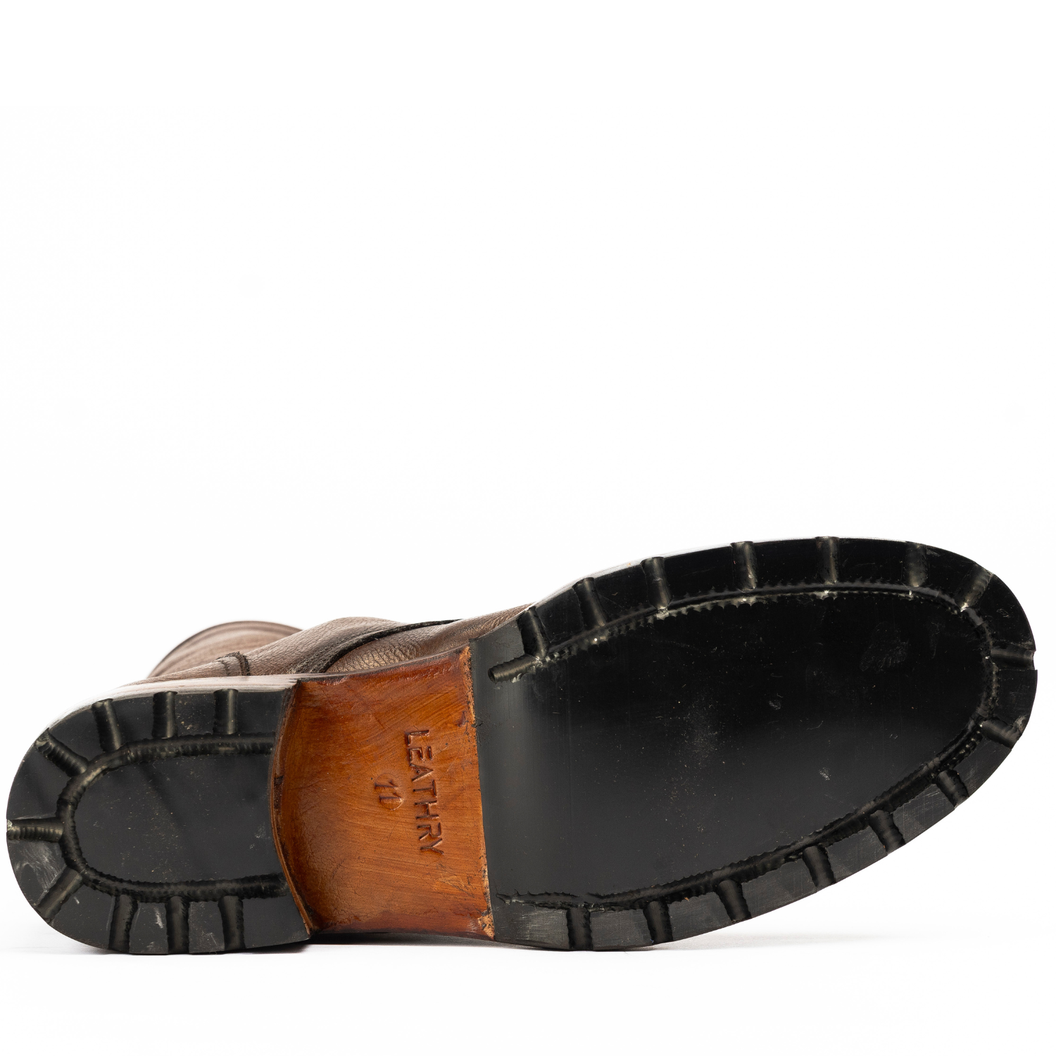 Close-up of a leather shoe sole with 'Leather' branding on a white background