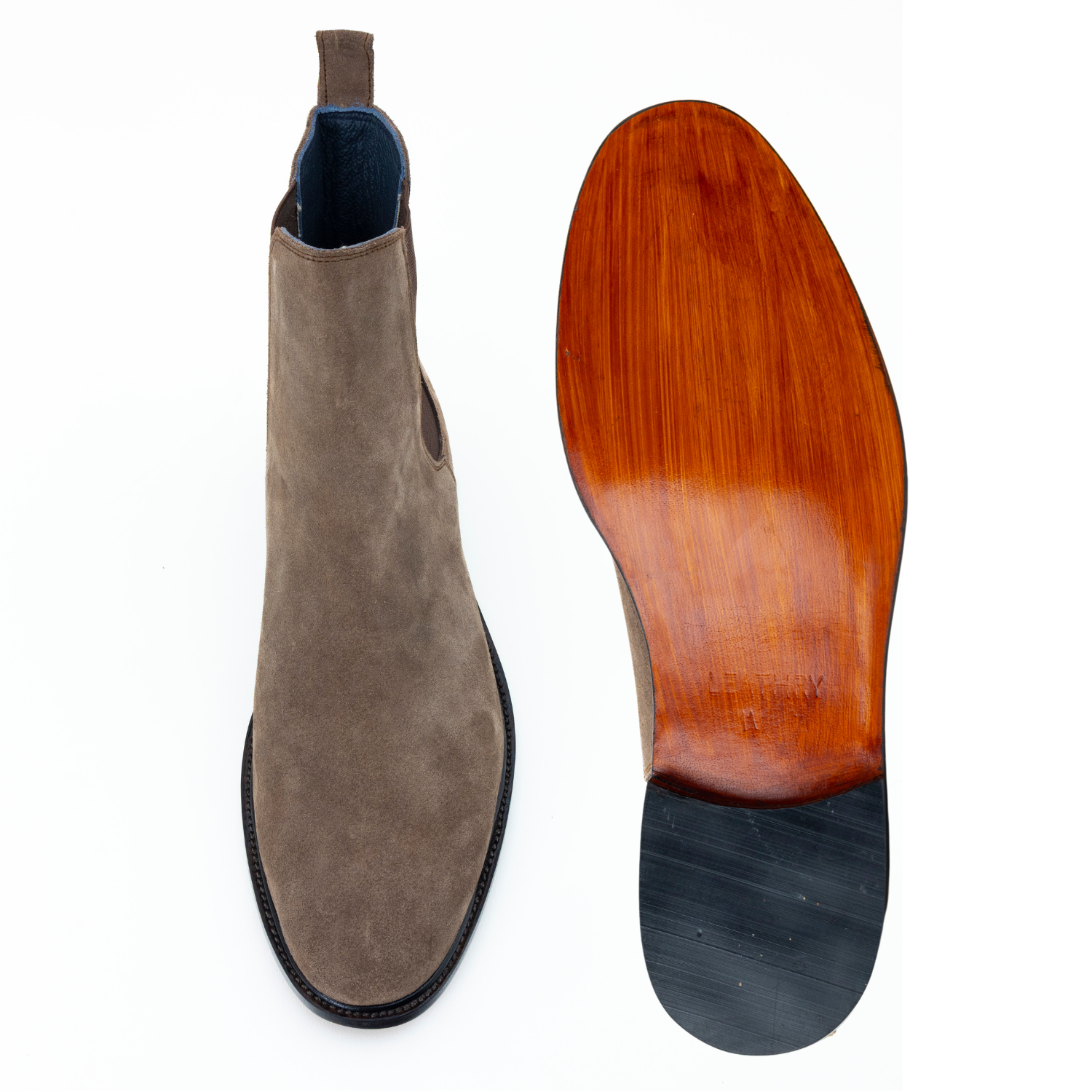 Brown suede boot and wooden sole on a white background