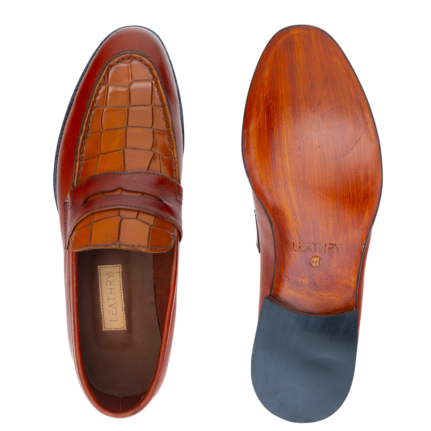 Brown leather loafer shoe with a detailed sole on a white background