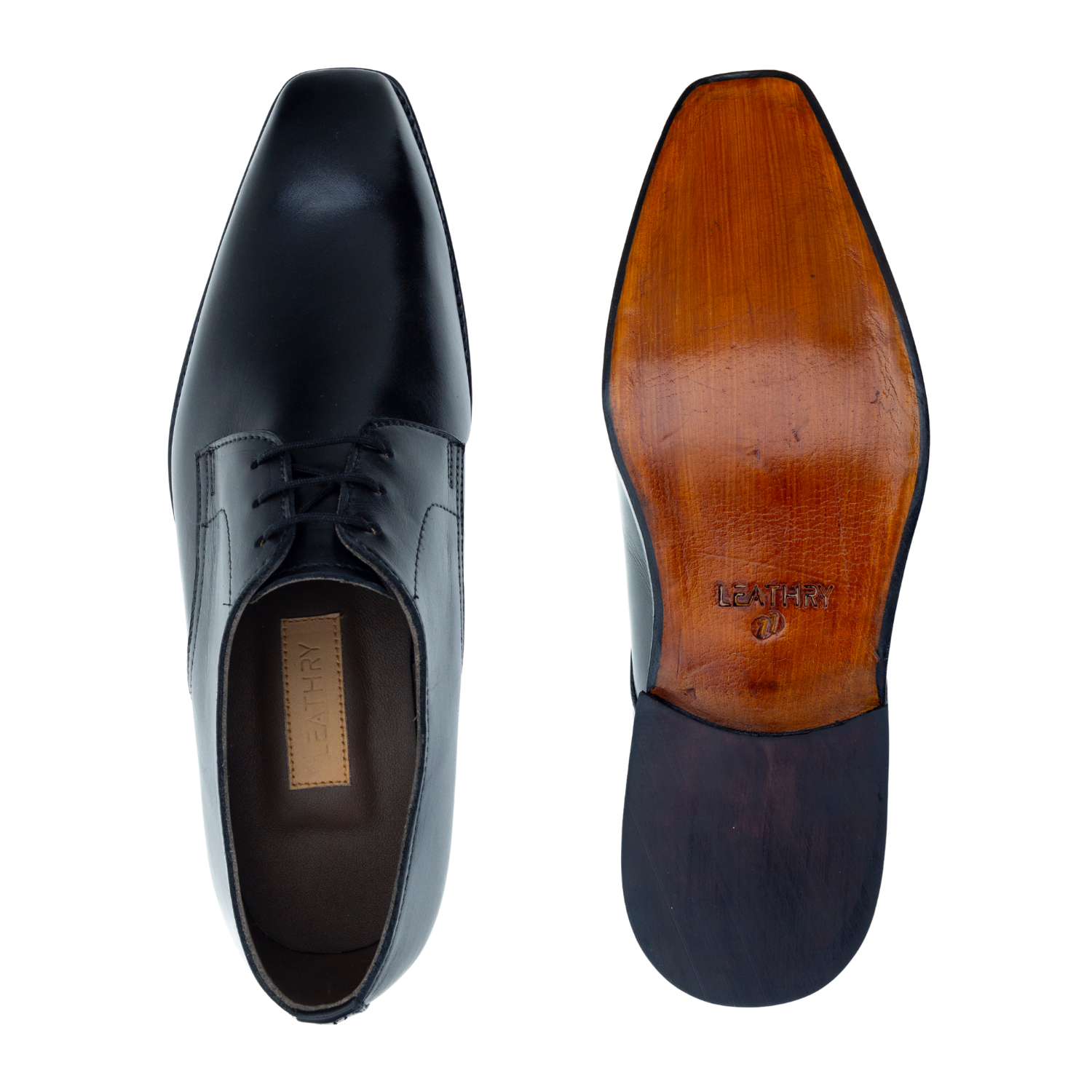 Black dress shoes with brown soles on a white background