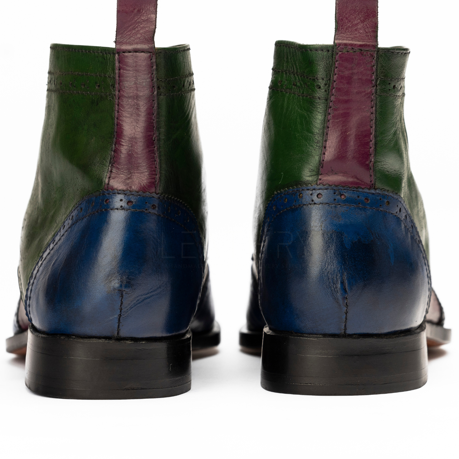 Green and blue leather boots with purple accents on a white background