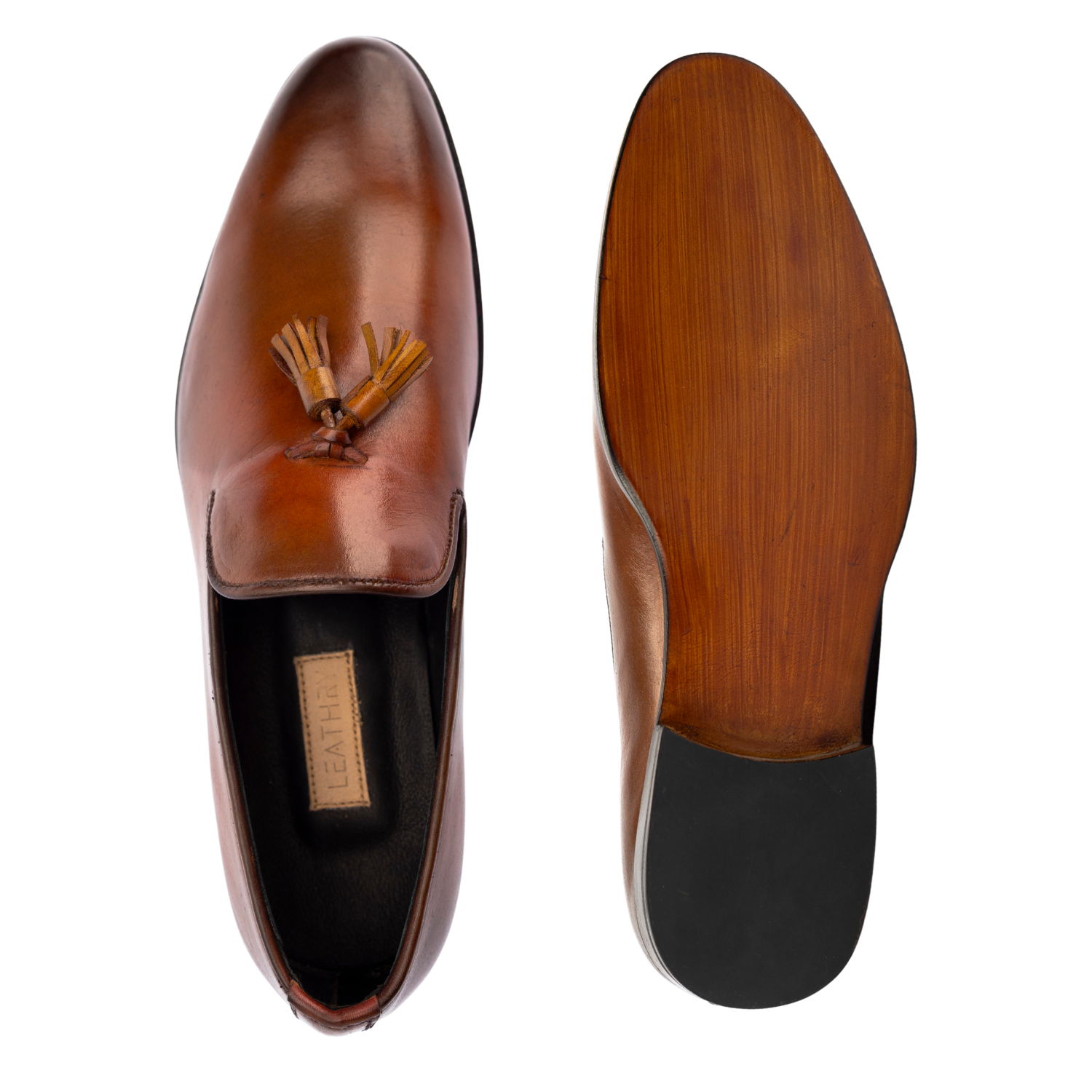 Brown leather loafer with tassel on a white background