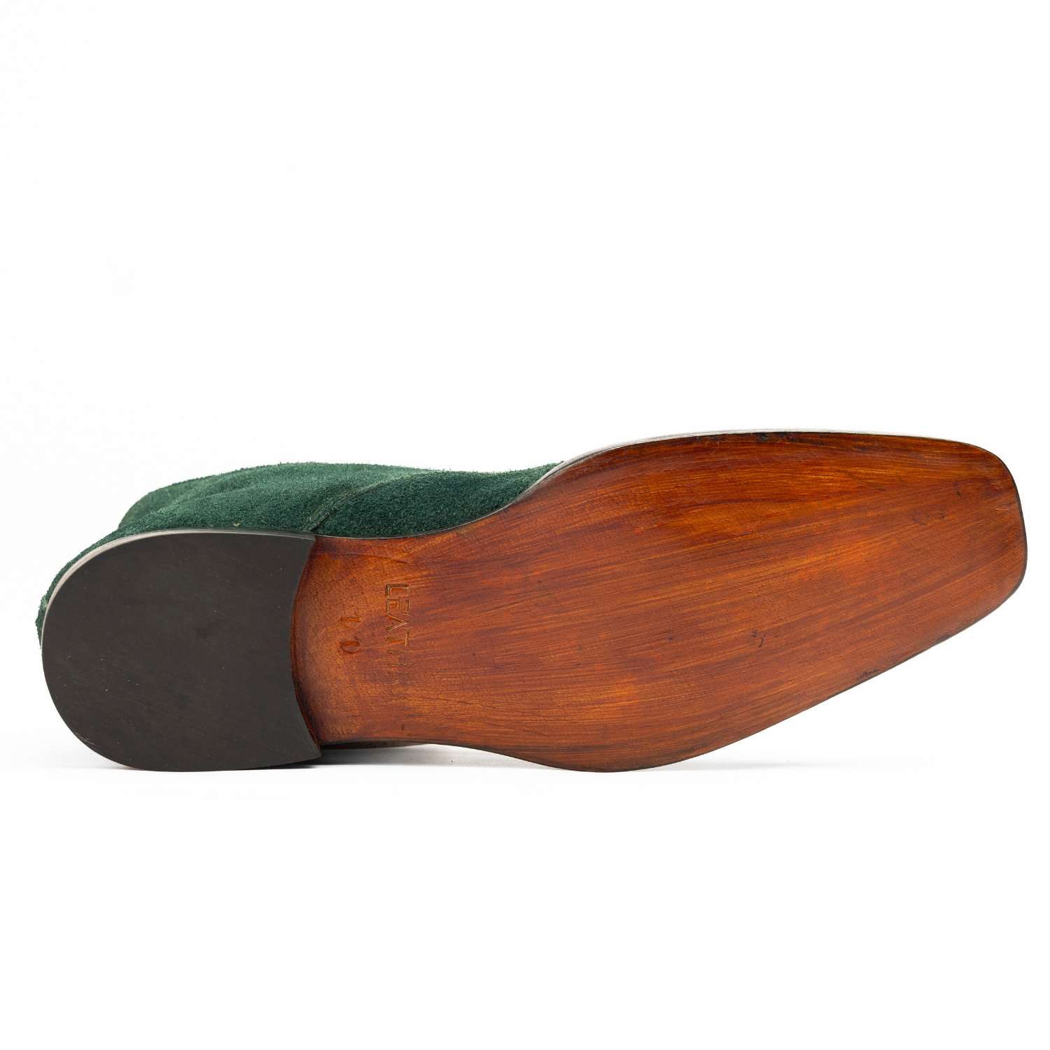 Close-up of a shoe sole with wooden finish on a white background