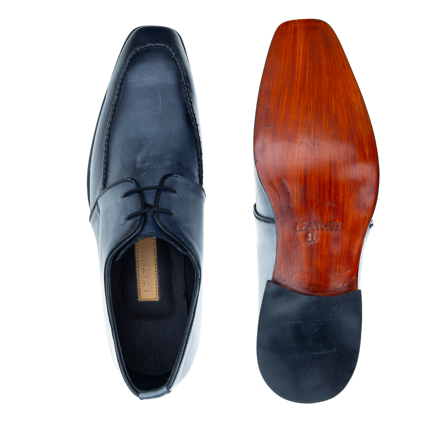 Black leather shoe with wooden sole on a white background