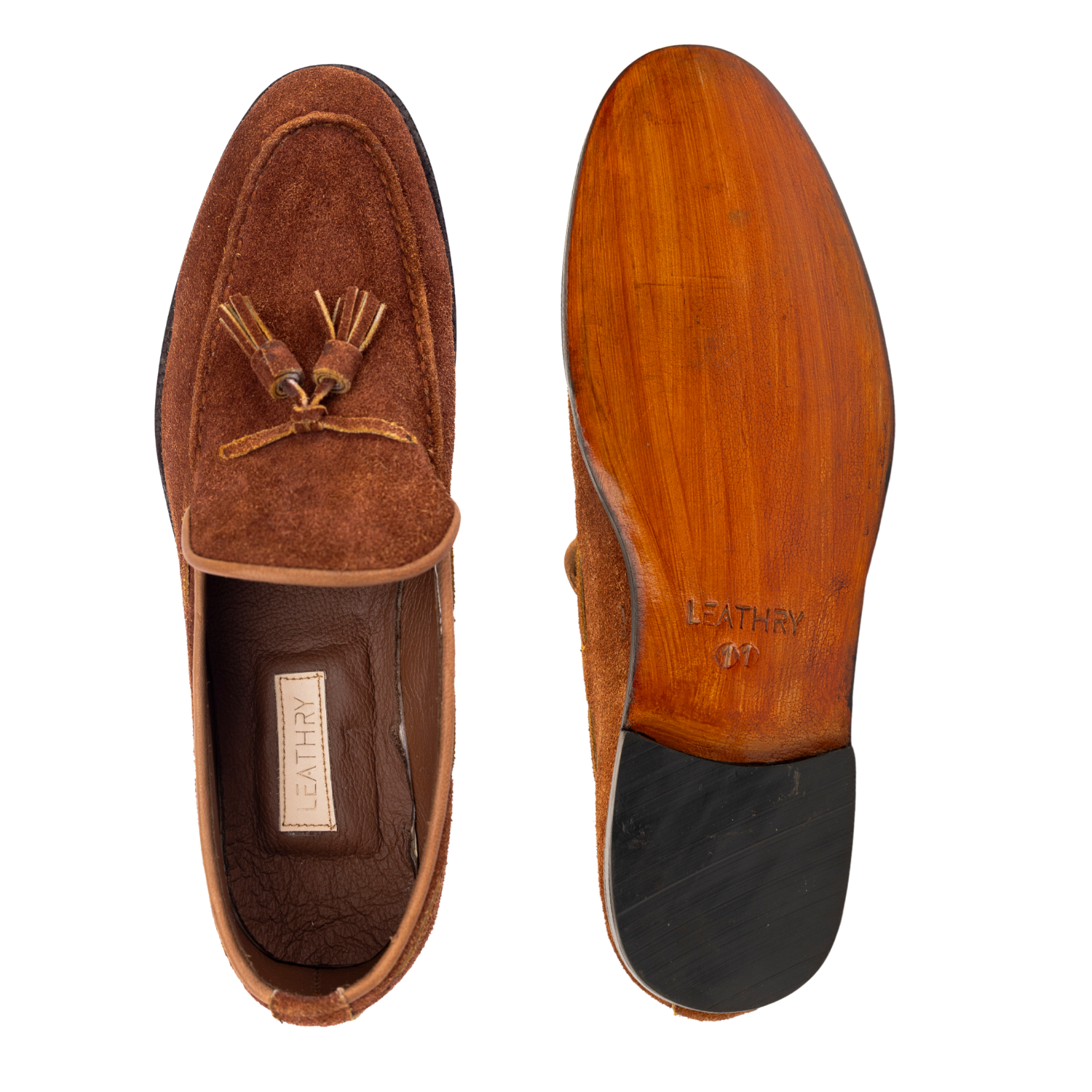 Brown suede loafer with tassel on a white background