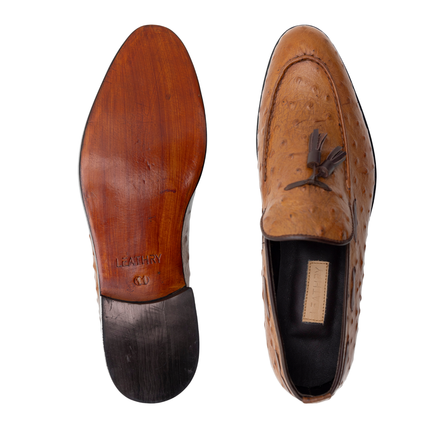 Brown leather loafer with tassel on a white background