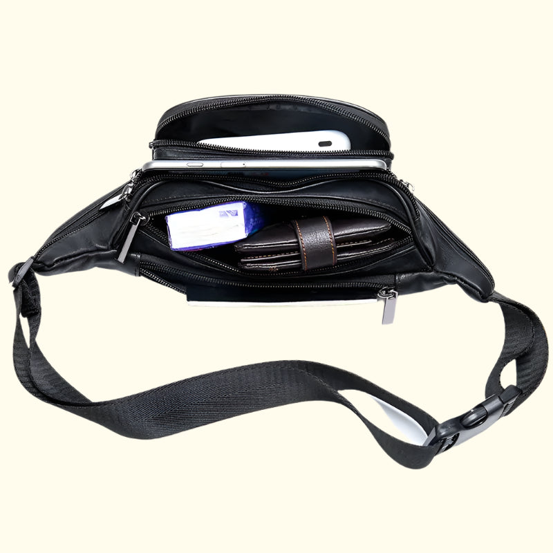 Black crossbody bag with compartments and a phone inside on a white background