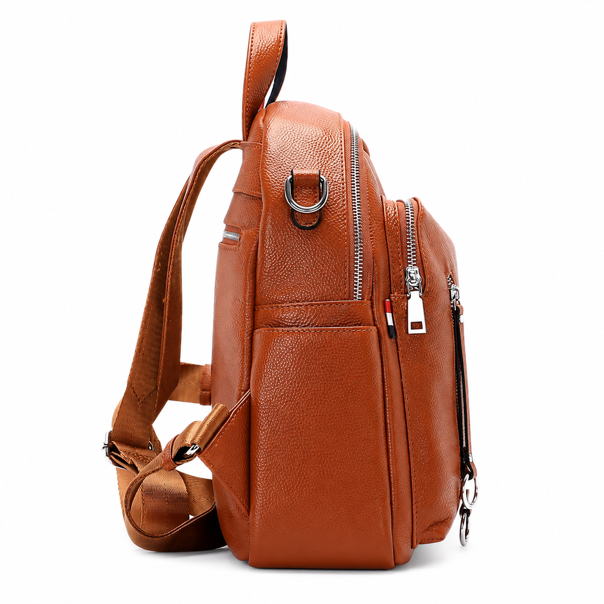 A brown textured leather sling backpack shown from a three-quarter side view, featuring a single shoulder strap, multiple zippered pockets, and silver-tone metal hardware, set against a plain white background.