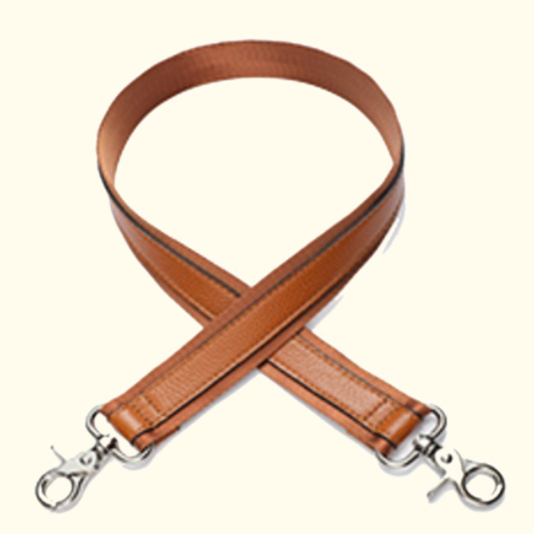 Brown leather strap with silver hardware on a white background