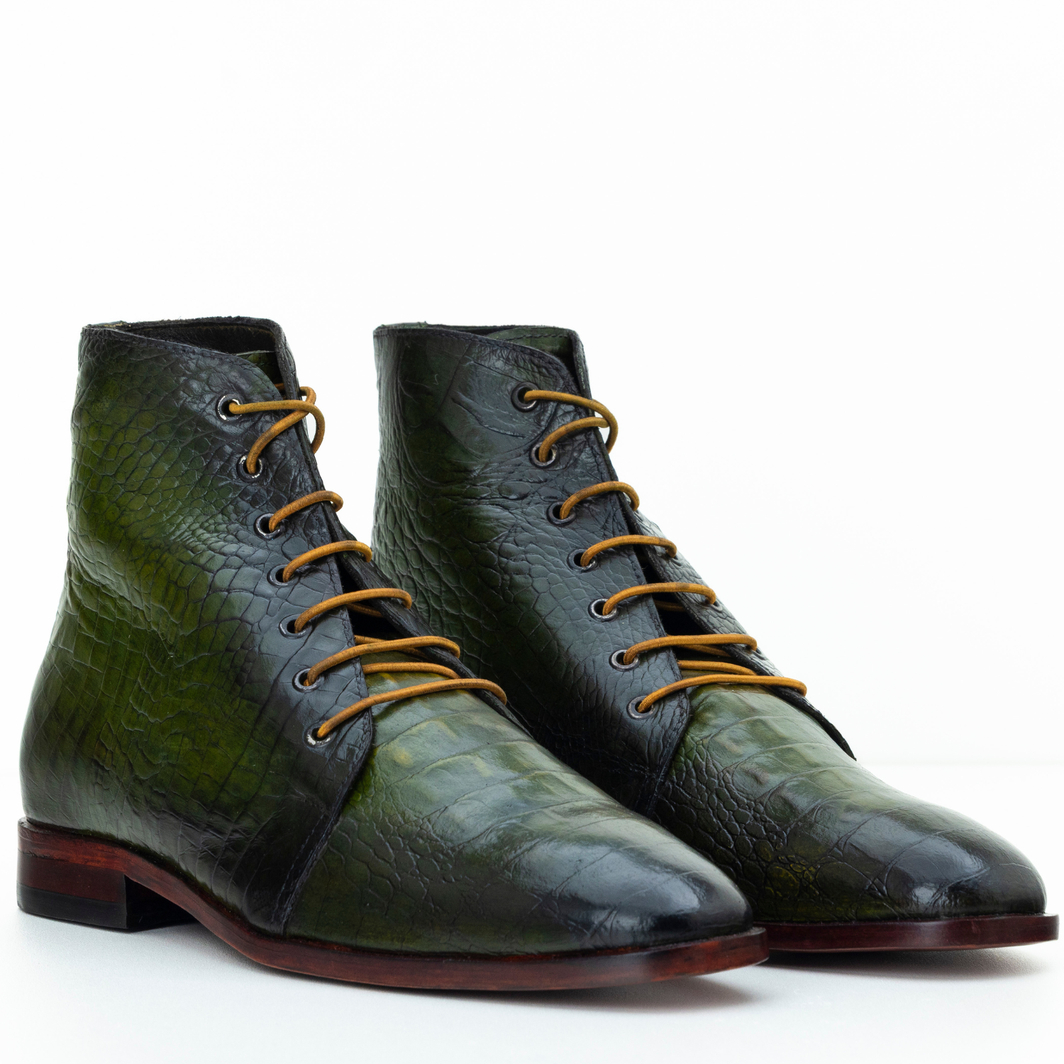 Green leather boots with brown laces on a white background