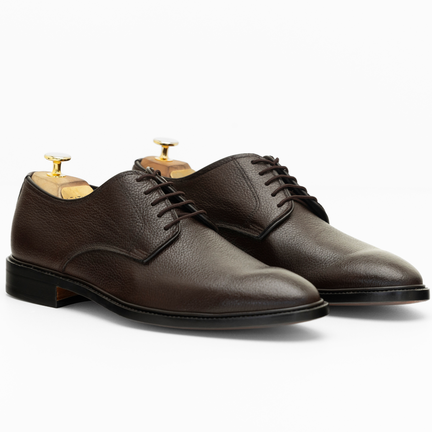 Pair of brown leather dress shoes on a white background