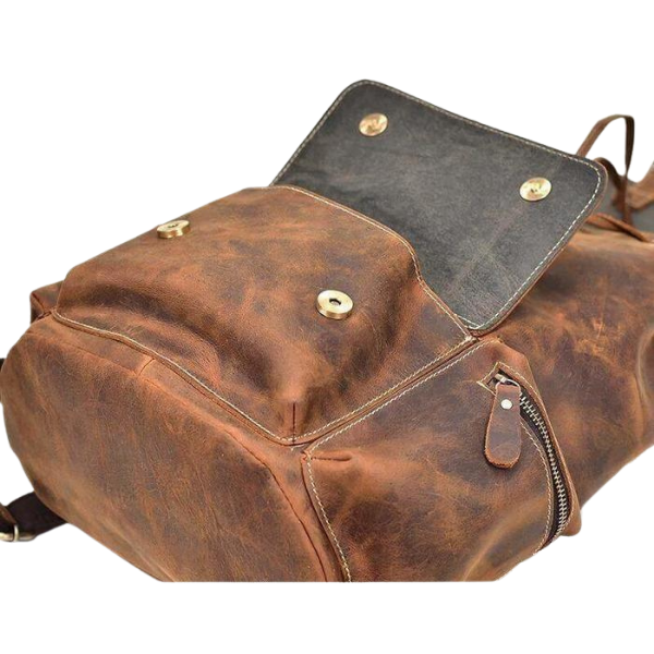 Brown leather backpack with gold rivets on a white background