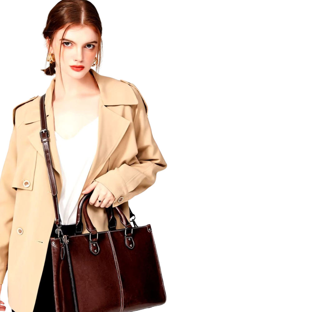 Woman holding a brown leather handbag against a white background