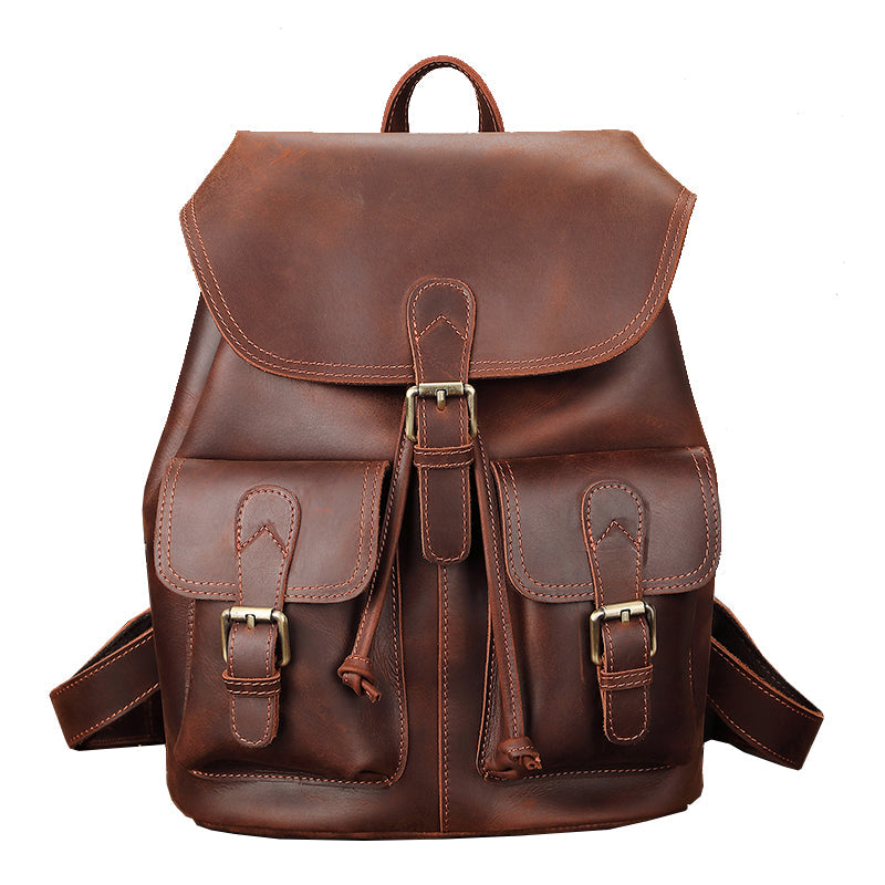 Brown leather backpack with gold buckles on a white background