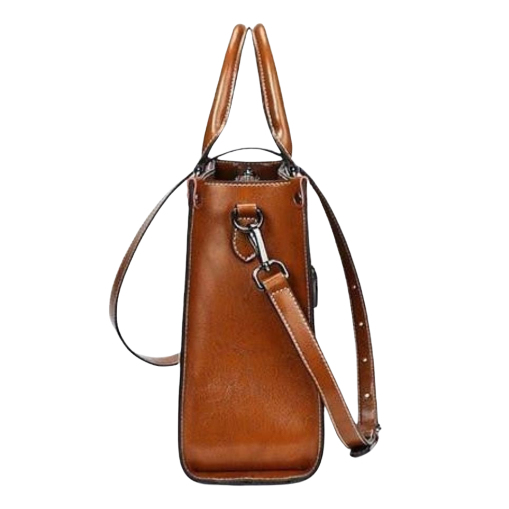 Brown leather handbag with shoulder strap on a white background